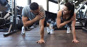 Image of man and woman doing Cardio Rowley Regis to tone their arms. 